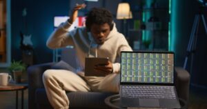 african american person using his tablet laying couch