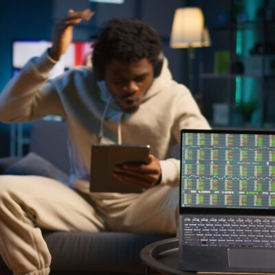 african american person using his tablet laying couch